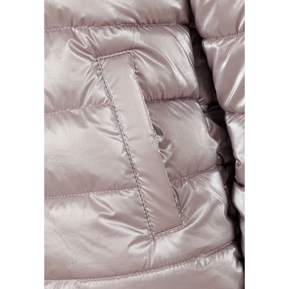 Close-up detail of lilac padded jacket showing quilted texture, zip closure and front pocket