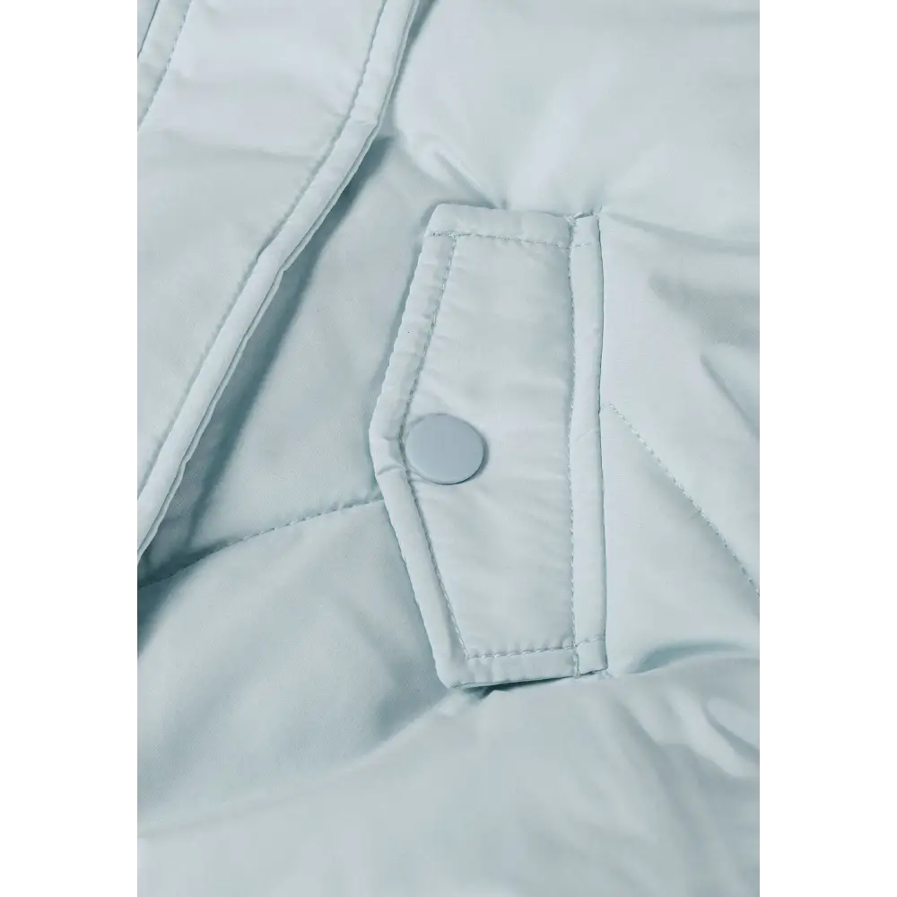 Detail view of light blue snowsuit front opening showing zip closure with press studs and quilted padding pattern