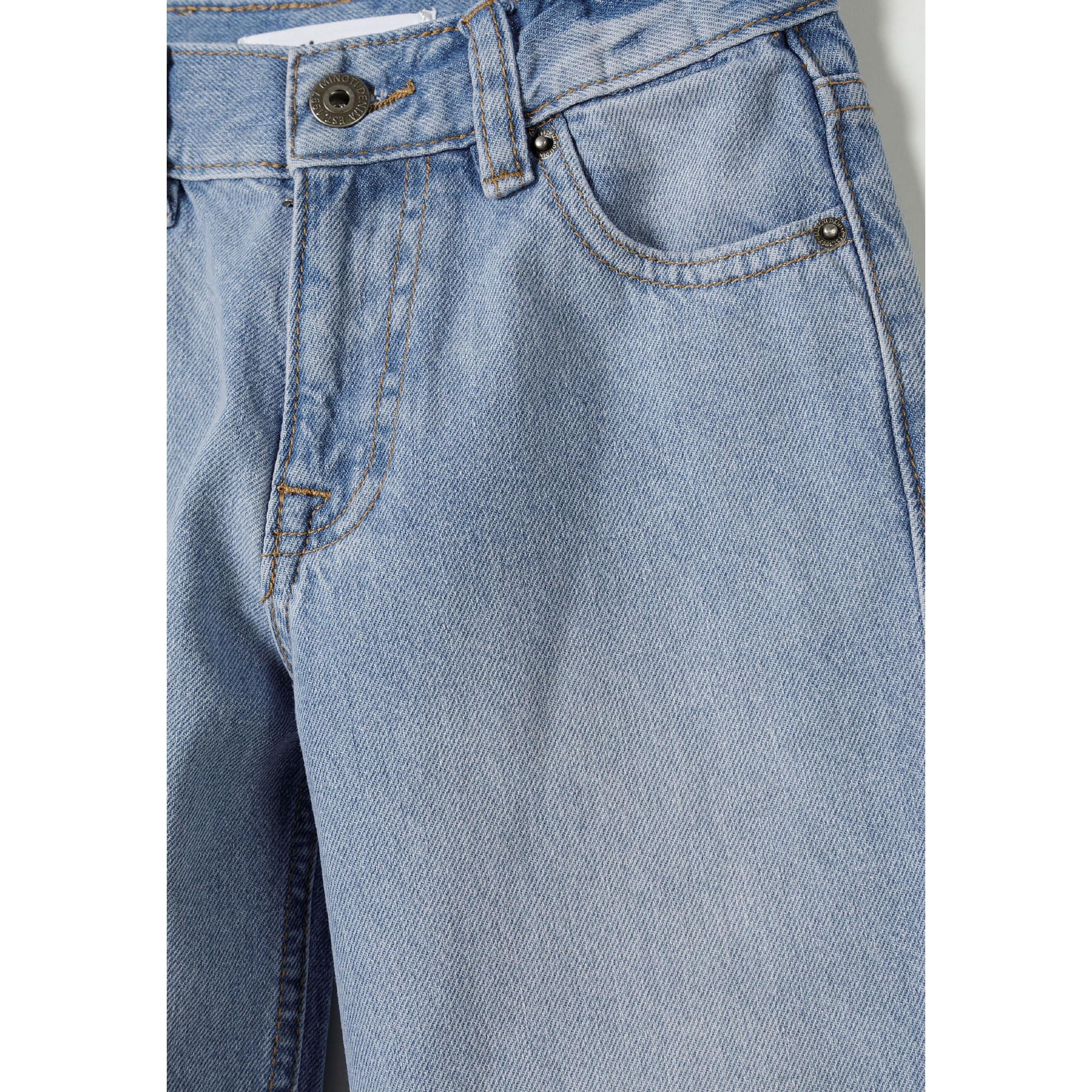 Close-up detail of light blue denim waistband showing button fastening, belt loops and front pocket construction with orange contrast stitching