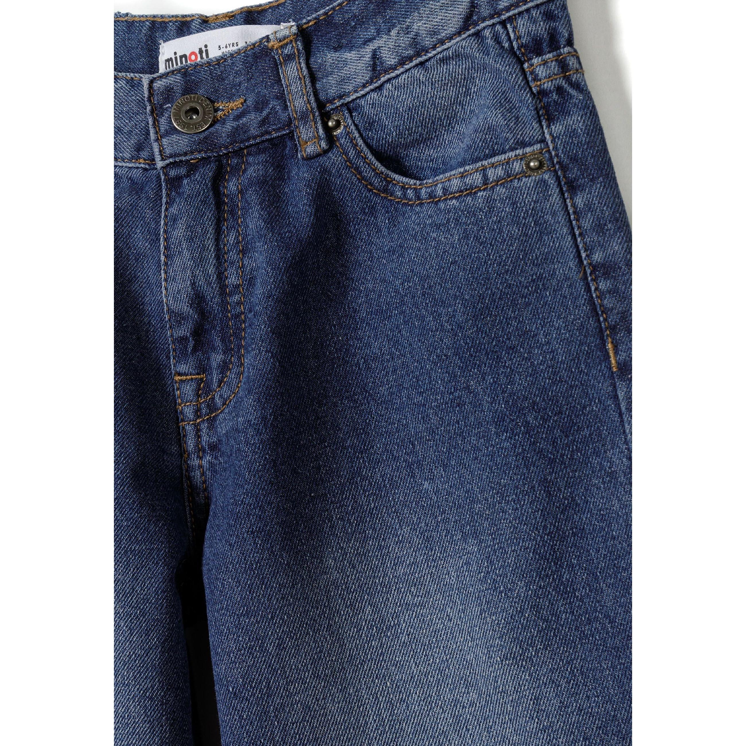 Close-up detail of navy baggy fit jeans showing Minoti label, front pocket and zip closure construction