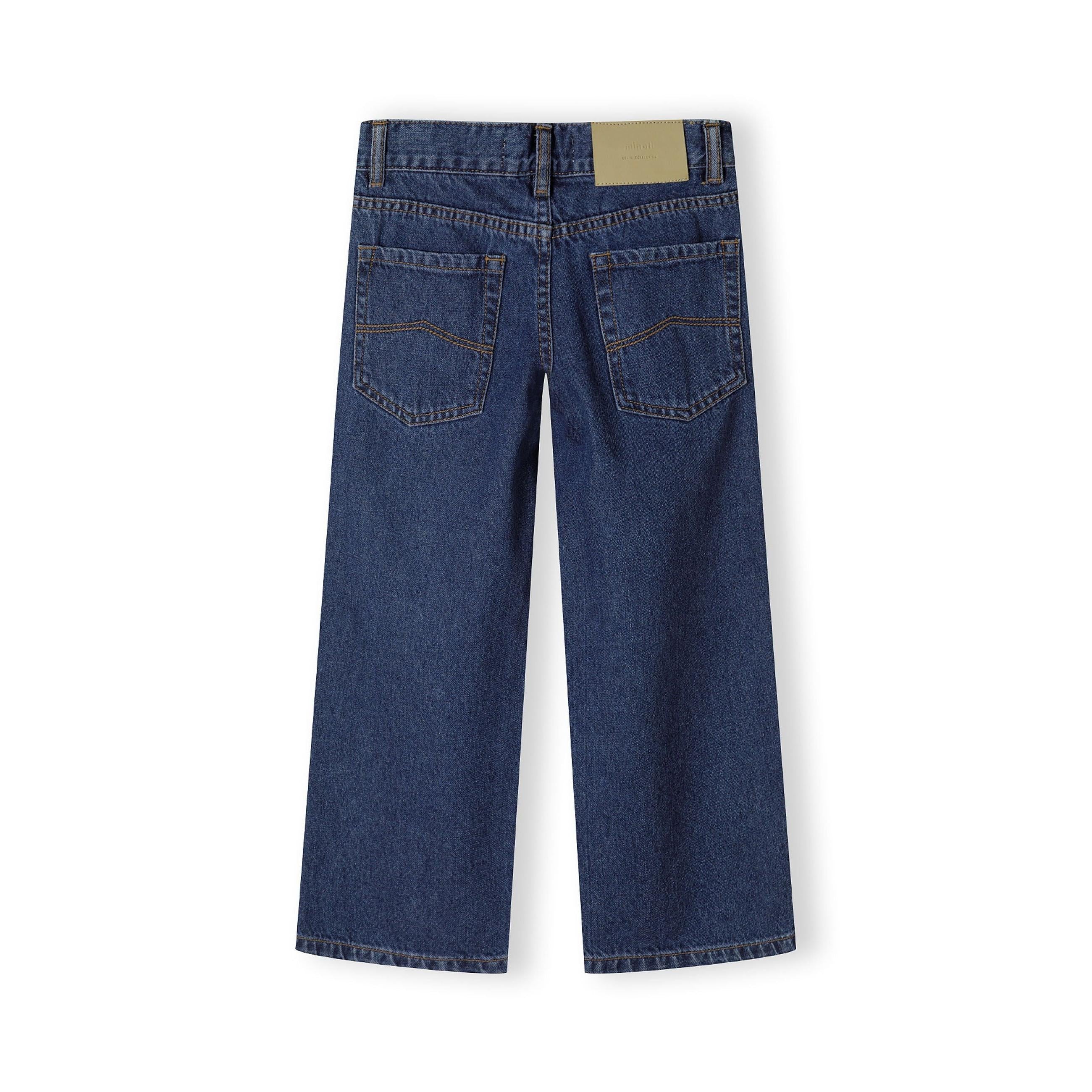 Back view of navy baggy fit jeans showing traditional five-pocket styling and waistband label on white background