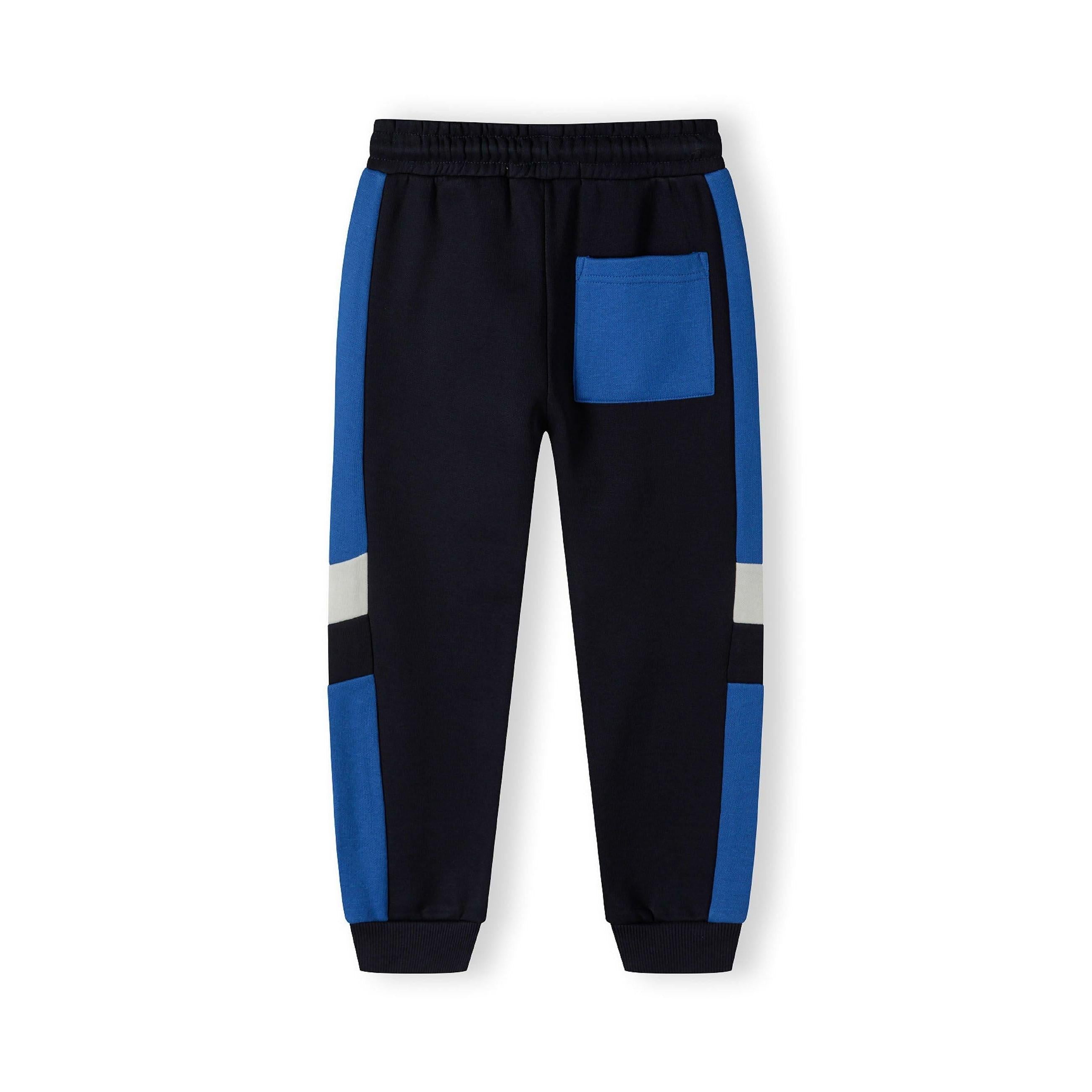 Close-up detail of navy jogger waistband with blue drawstring ties and side panel construction