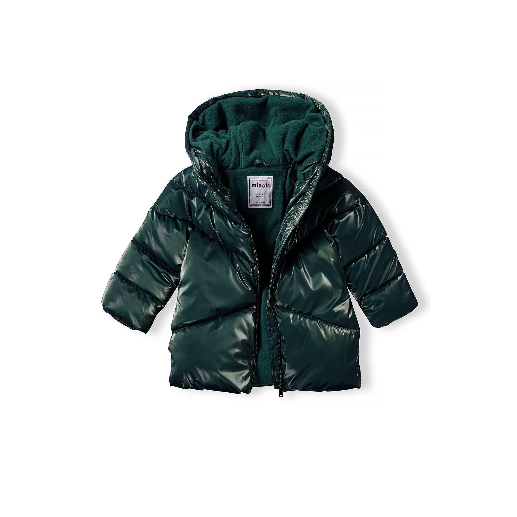 Close-up detail of metallic dark green fabric texture showing quilted padding and shiny finish