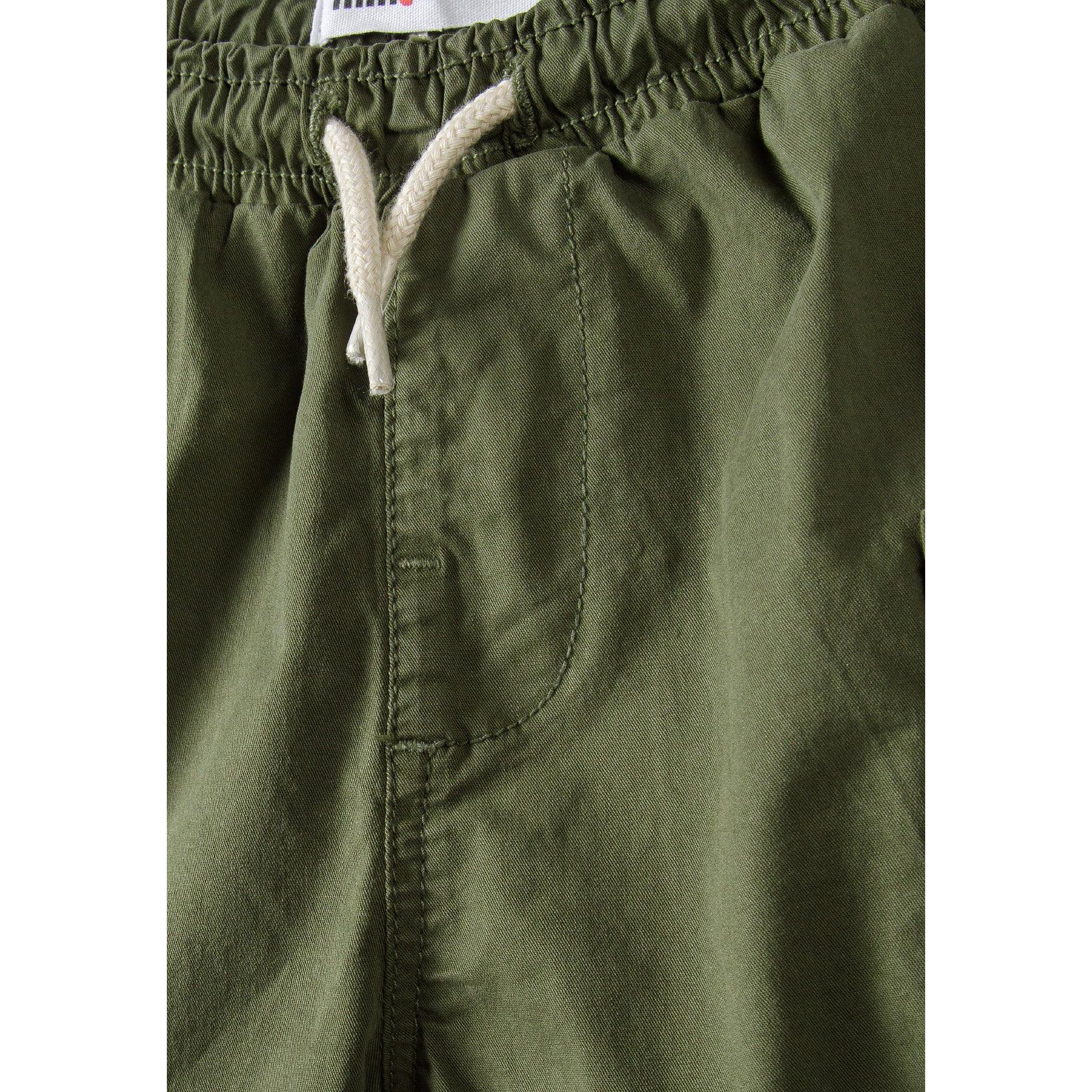Close-up detail of elasticated waistband with white drawstring and Minoti label visible