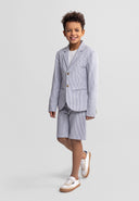 Boy wearing a tailored navy blue striped cotton blazer and matching shorts with casual sneakers, smiling confidently.