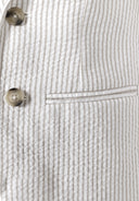 Close-up of striped cotton fabric with button and pocket detail on boys blazer design.