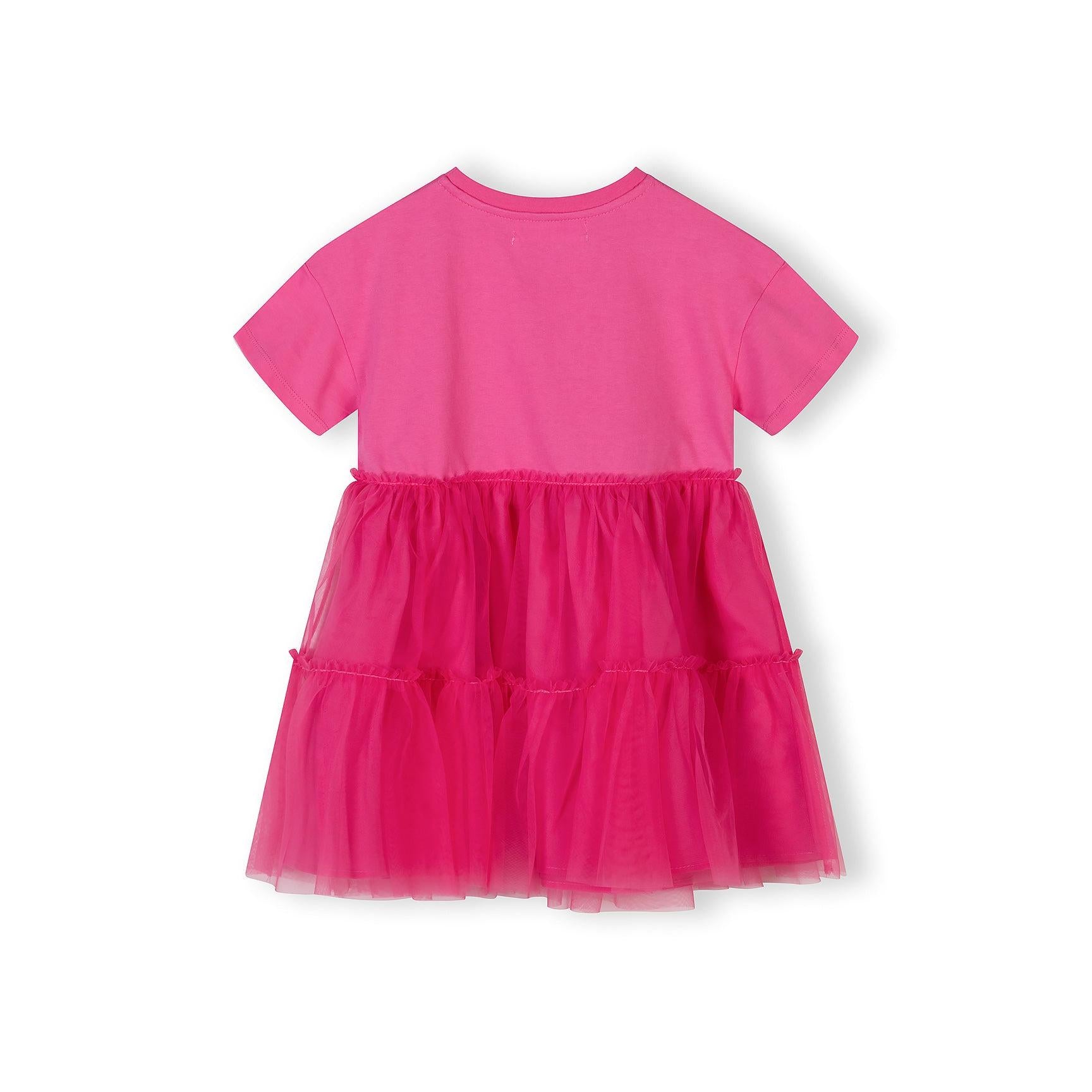 Back view of pink jersey dress showing plain cotton bodice and layered tulle skirt construction against white background
