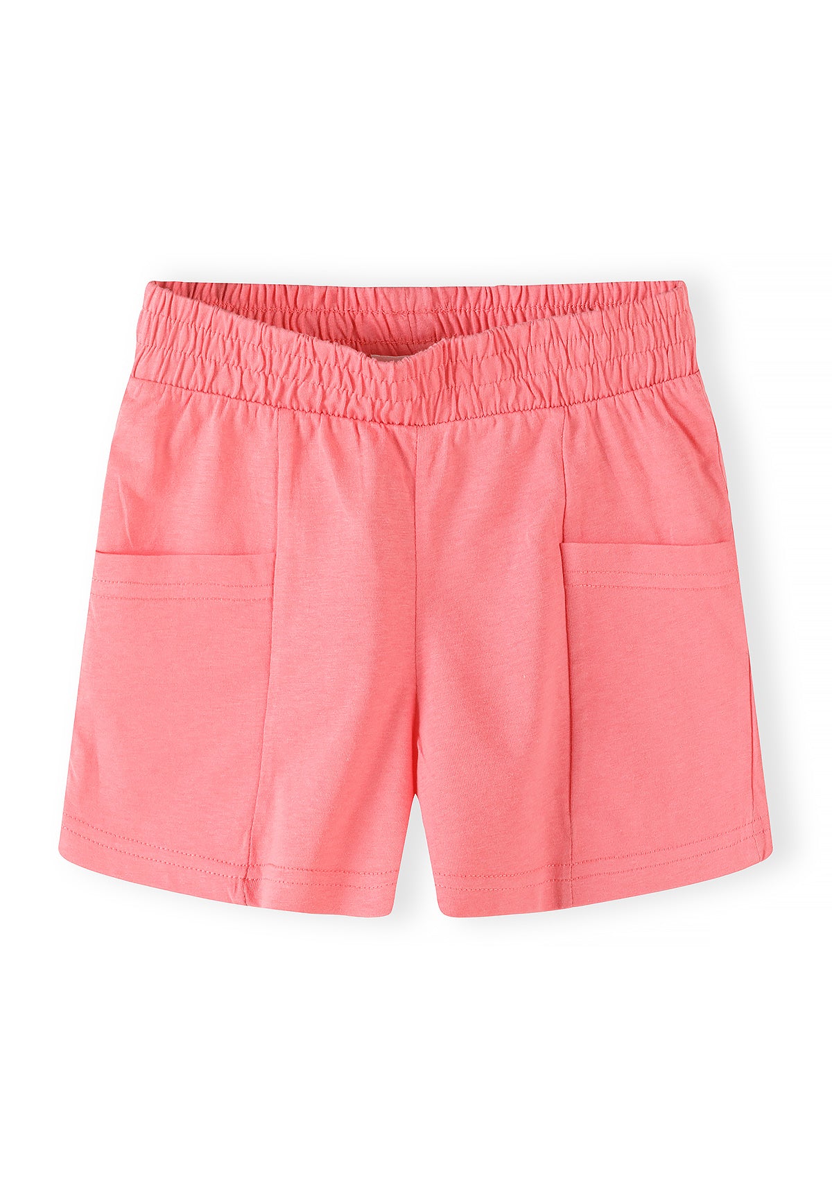 Close-up detail of tropical print jersey shorts showing vibrant pineapple, flamingo and palm leaf pattern with elasticated shirred waistband
