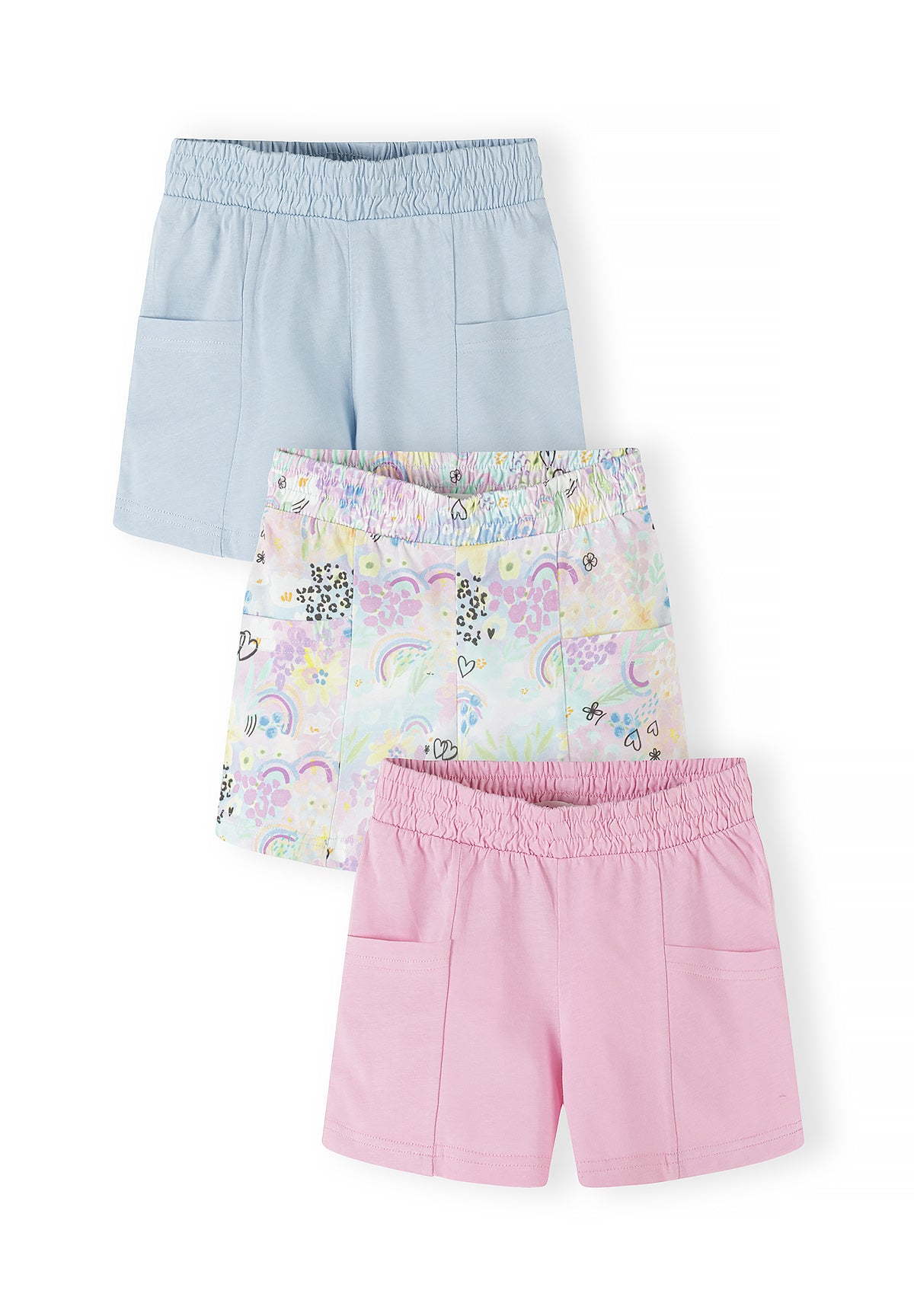 Three jersey shorts laid flat showing light blue solid, multicolour rainbow print, and pink solid styles with elastic waistbands and side pockets on white background