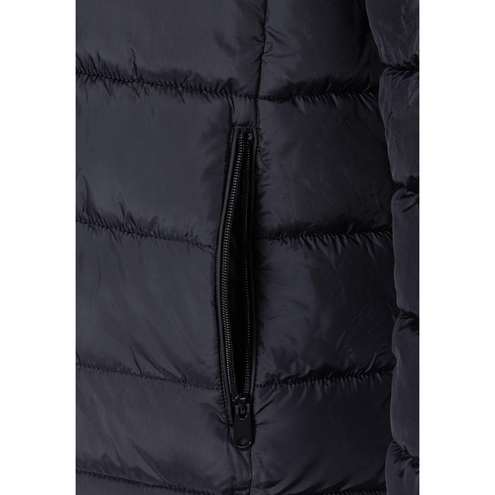 Close-up detail of navy blue padded jacket showing quilted texture, zip closure and stitching on white background