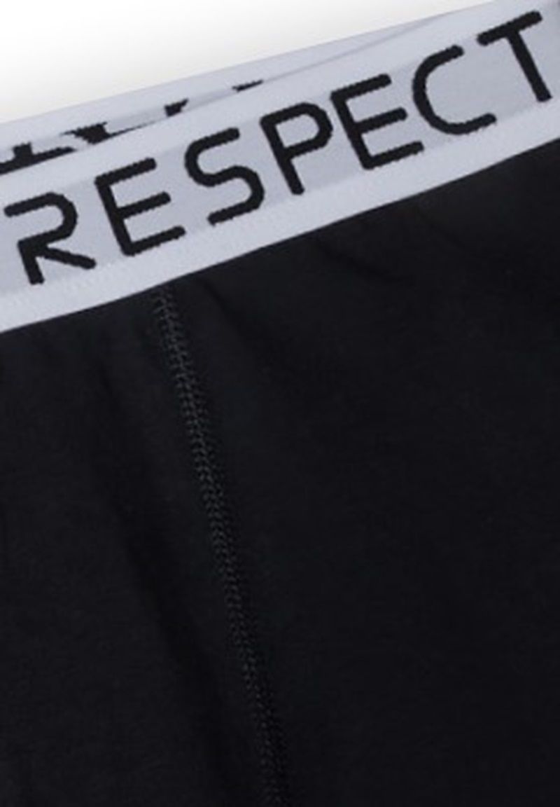 Black boxer trunks, white Respect waistband and front seam.