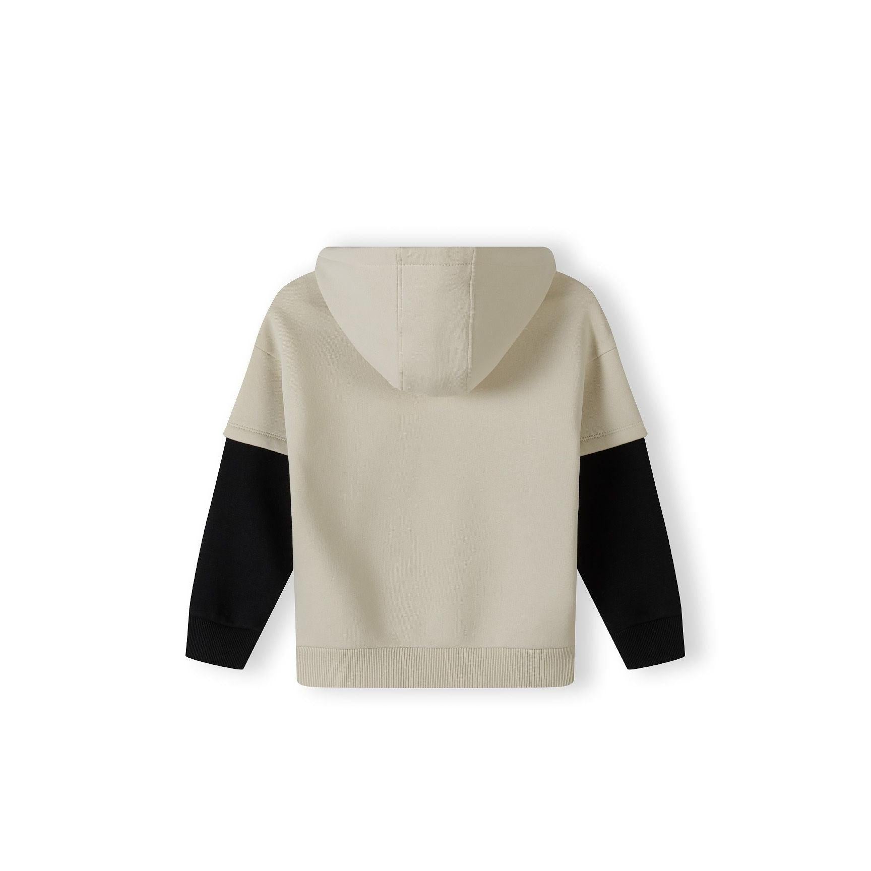 Back view of stone hoodie showing hood and black contrast sleeves laid flat