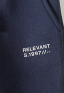 Navy boys slim fit joggers feature a front print with 'RELEVANT S.1997' text. Soft fleece fabric for ages 2-14y.
