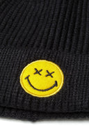 Black boys beanie with badge featuring a yellow smiley face applique. Designed for ages 6m-8y, offers warmth and comfort.
