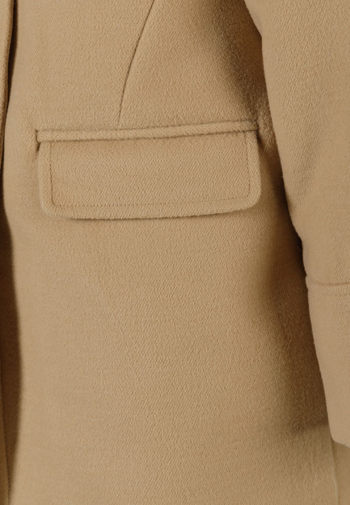 Close-up of the pocket on the camel hooded coat.