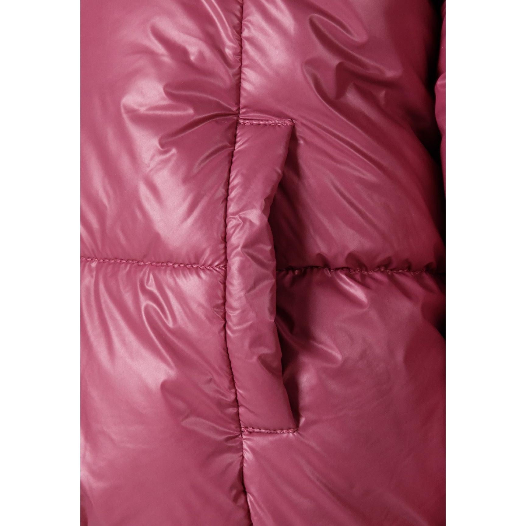 Close-up view of metallic purple reversible padded jacket showing quilted construction and white teddy fur hood interior, displayed flat on white background