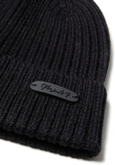 Knitted rib black beanie with subtle badge detail. Flexible ribbed knit fabric for girls 2-14y.