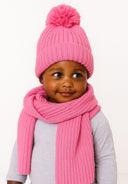 Close-up of a pink knitted hat with pom pom and matching scarf, ribbed design.
