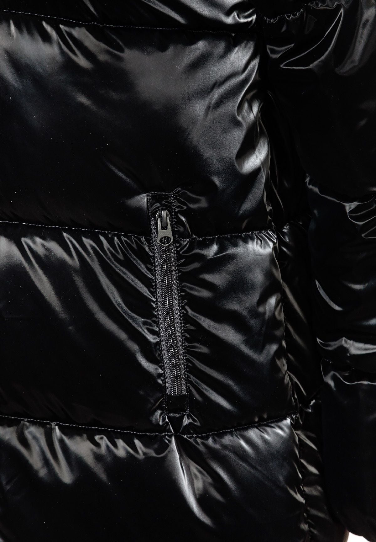 Close-up of the pocket on the black long puffer coat.