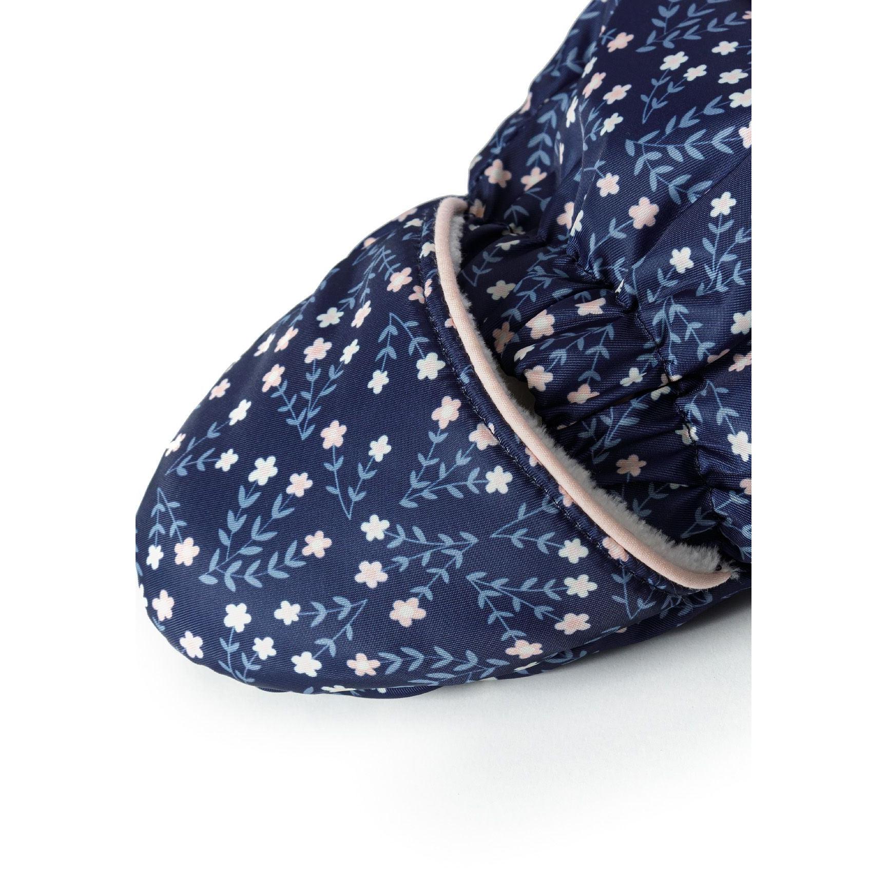 Close-up detail of navy fabric showing delicate floral pattern with small white and blue flowers and leaf motifs