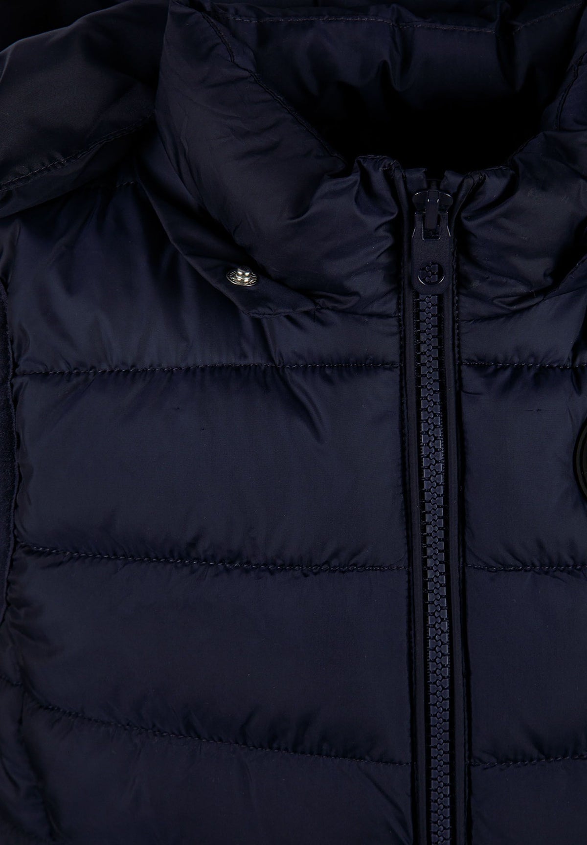 Navy padded gilet, hood attachment detail.