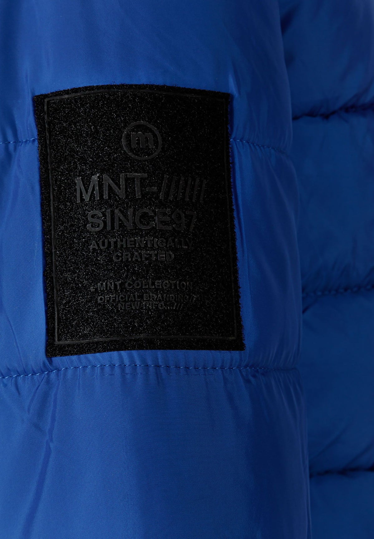 Close-up of the sleeve patch on the blue puffer jacket.