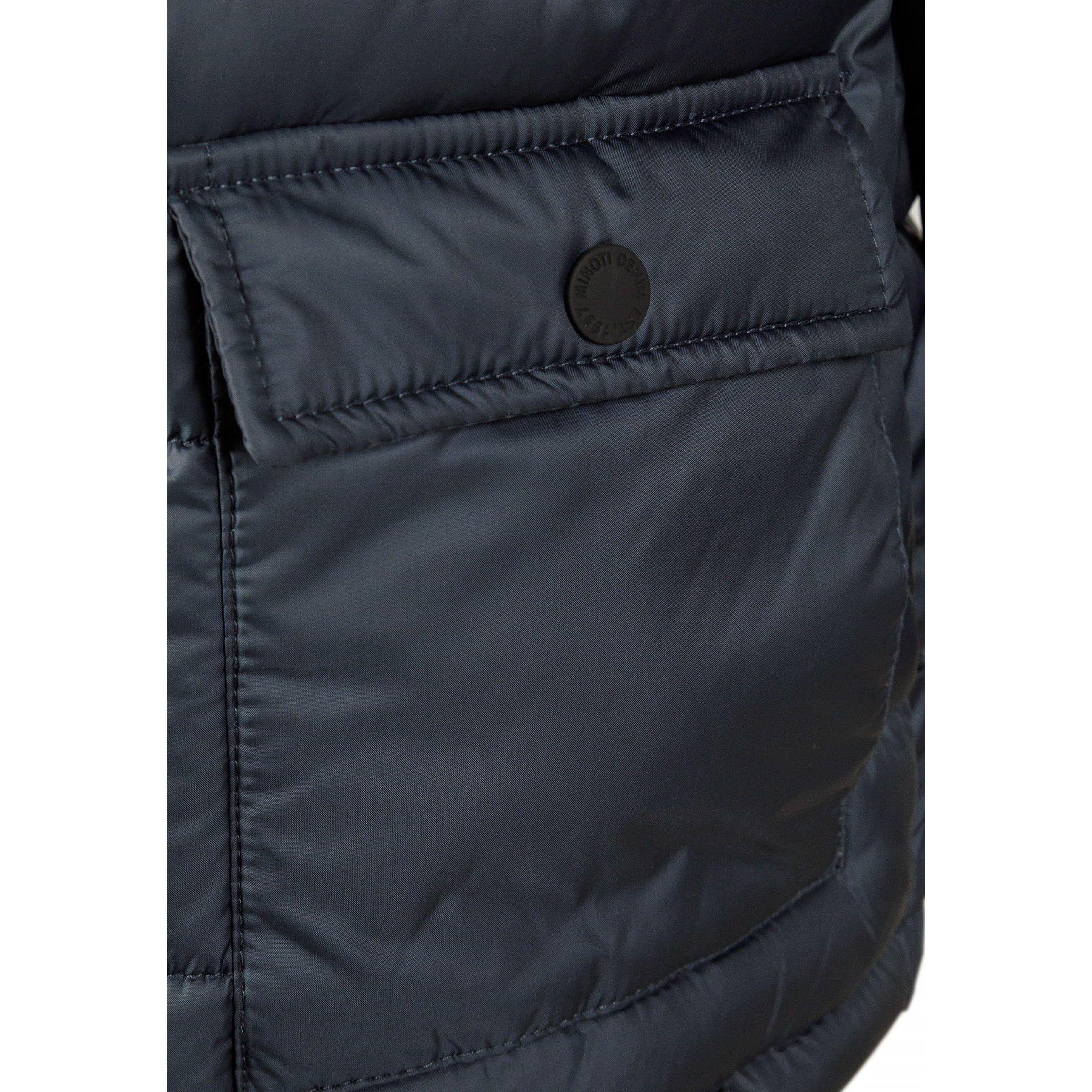 Close-up detail of navy jacket pocket with snap button closure and quilted stitching pattern