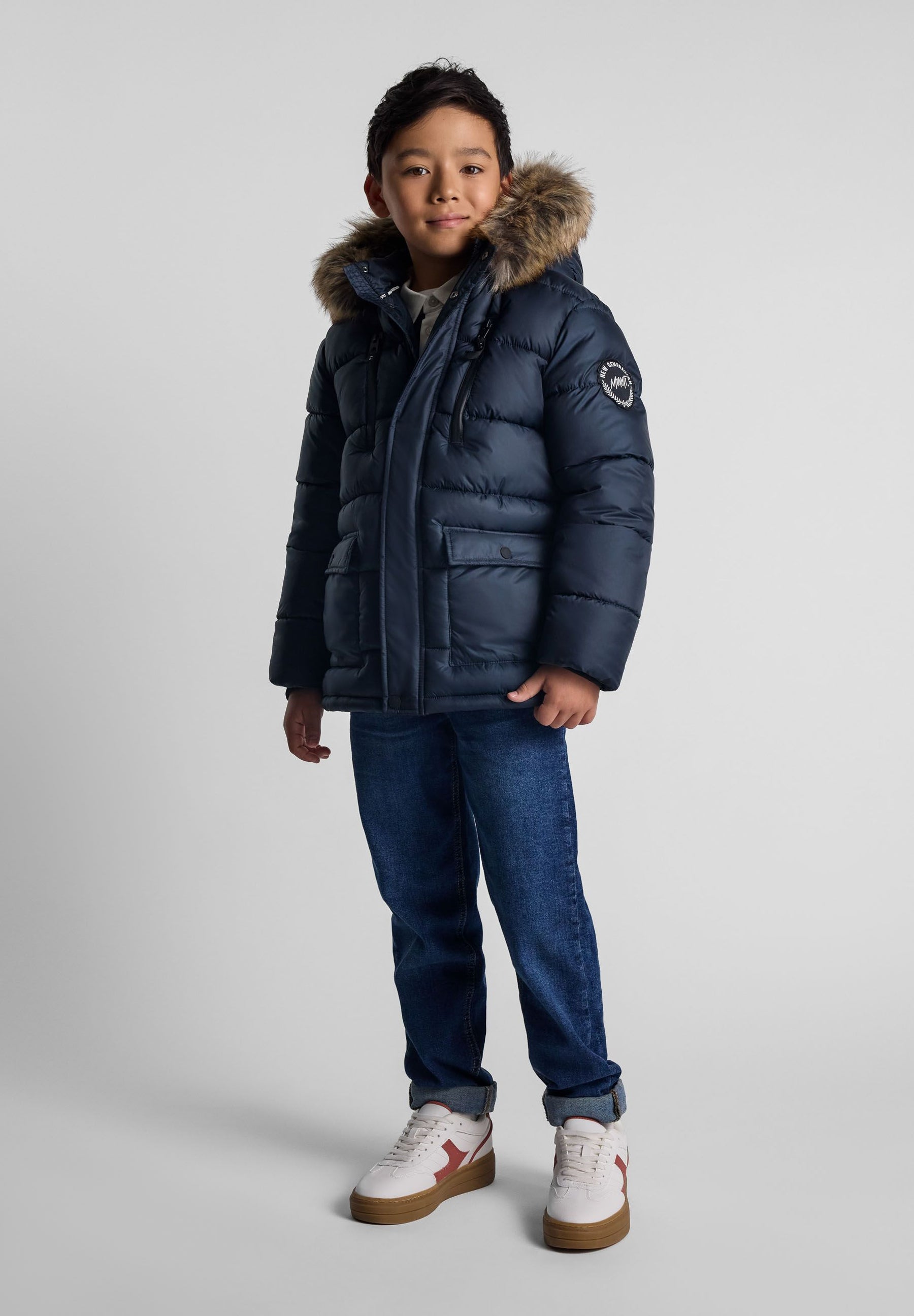 Boys navy jacket with detachable fur hood, front view, featuring fleece-lined pockets.