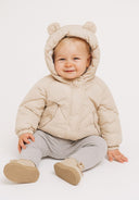Baby padded jacket in beige with 3D ears, front view, featuring a quilted design and snap button closure.