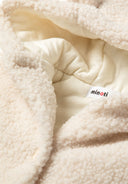 Detail of a cream baby jacket with teddy-style fabric, hood, and buttons.