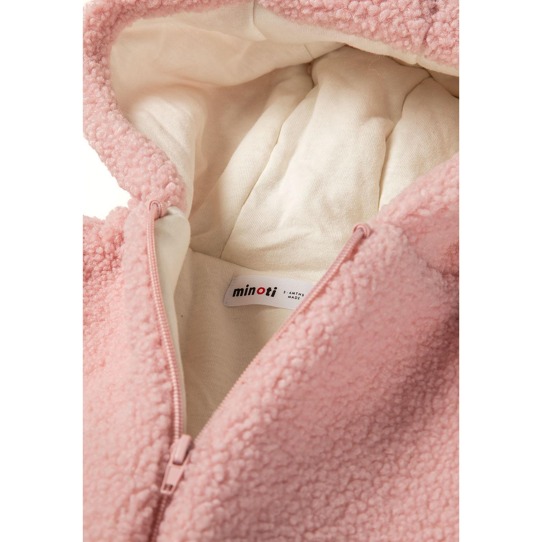 Close-up interior view showing cream jersey cotton lining and Minoti brand label inside the pink sherpa snowsuit