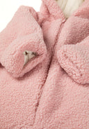 Close-up of a light pink sherpa snowsuit with 3D ears and front zip.
