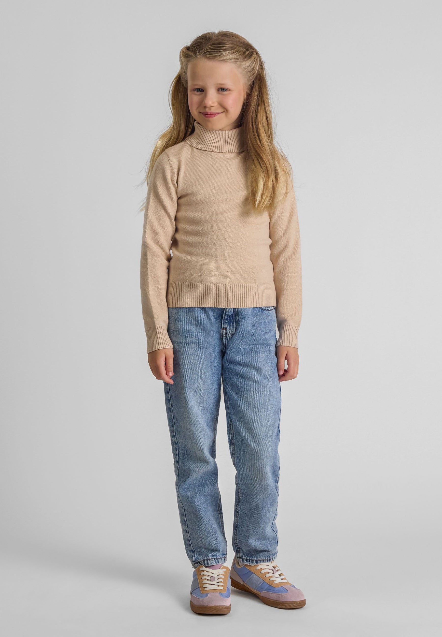 Girls beige turtleneck jumper with long sleeves, front view.
