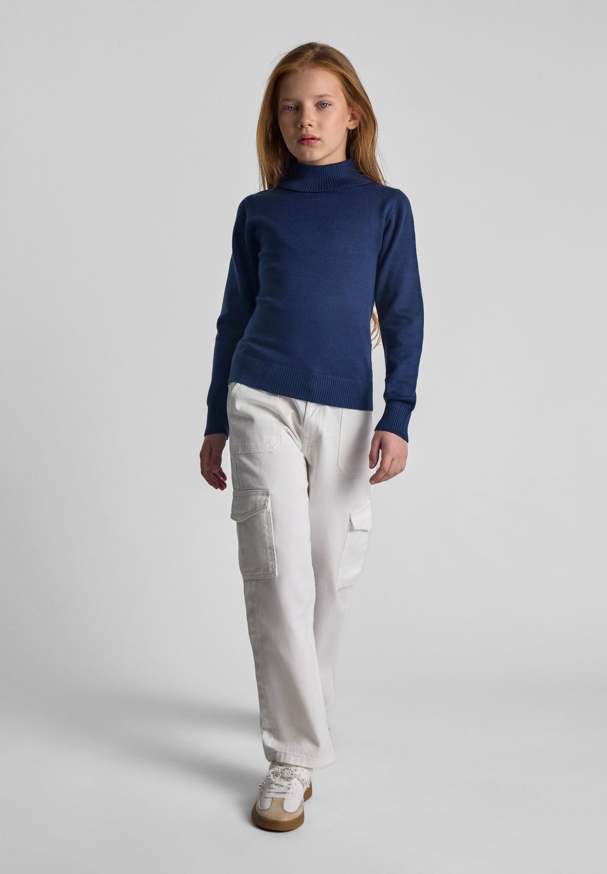 Navy high neck jumper, model front.