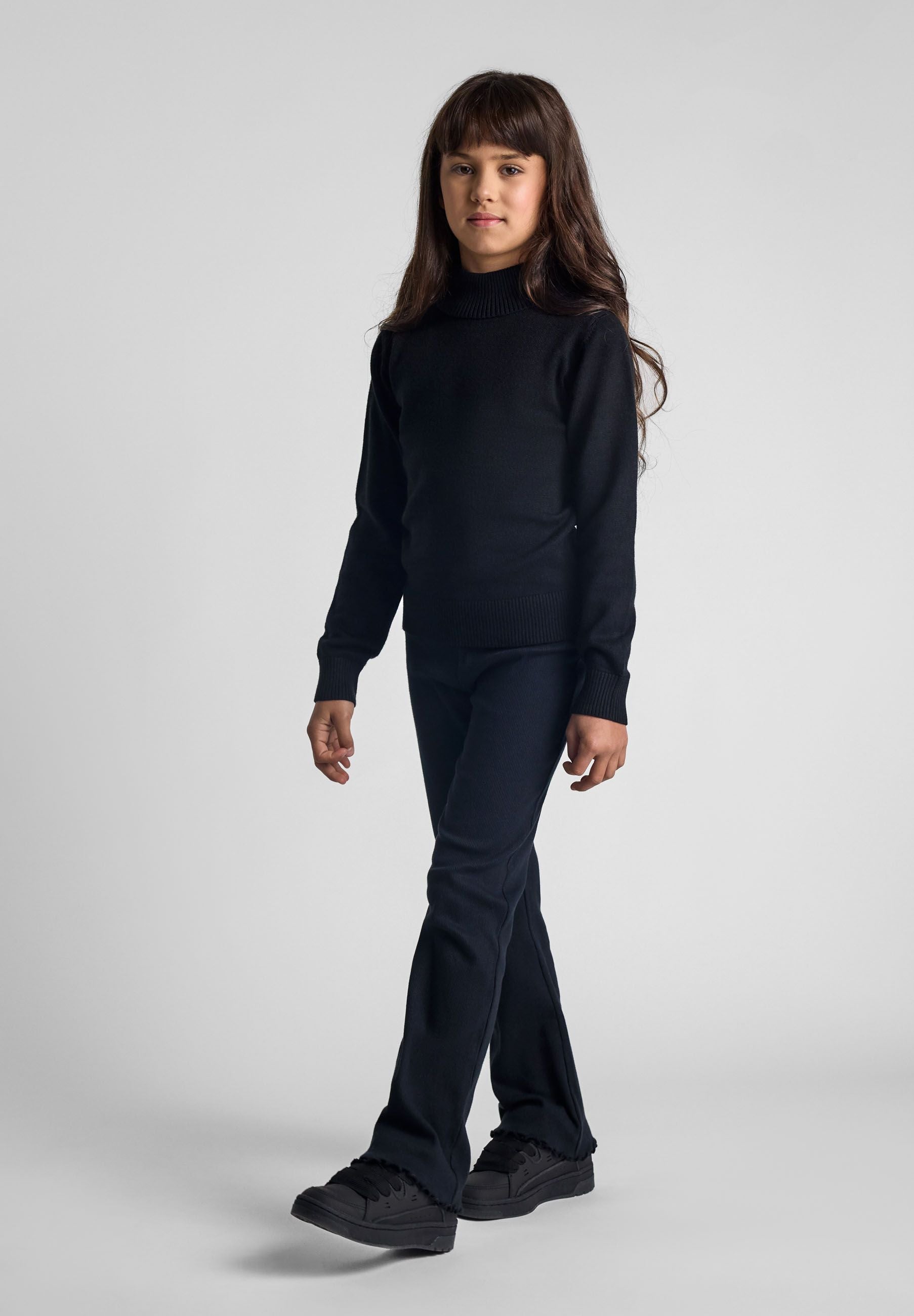 Girls black soft turtleneck jumper, front view, ribbed cuffs.