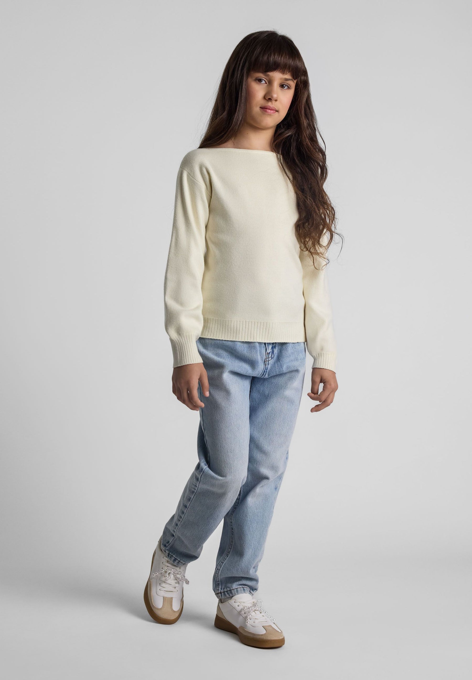 Girls cream jumper with boat neckline, long sleeves, and ribbed cuffs, front view.