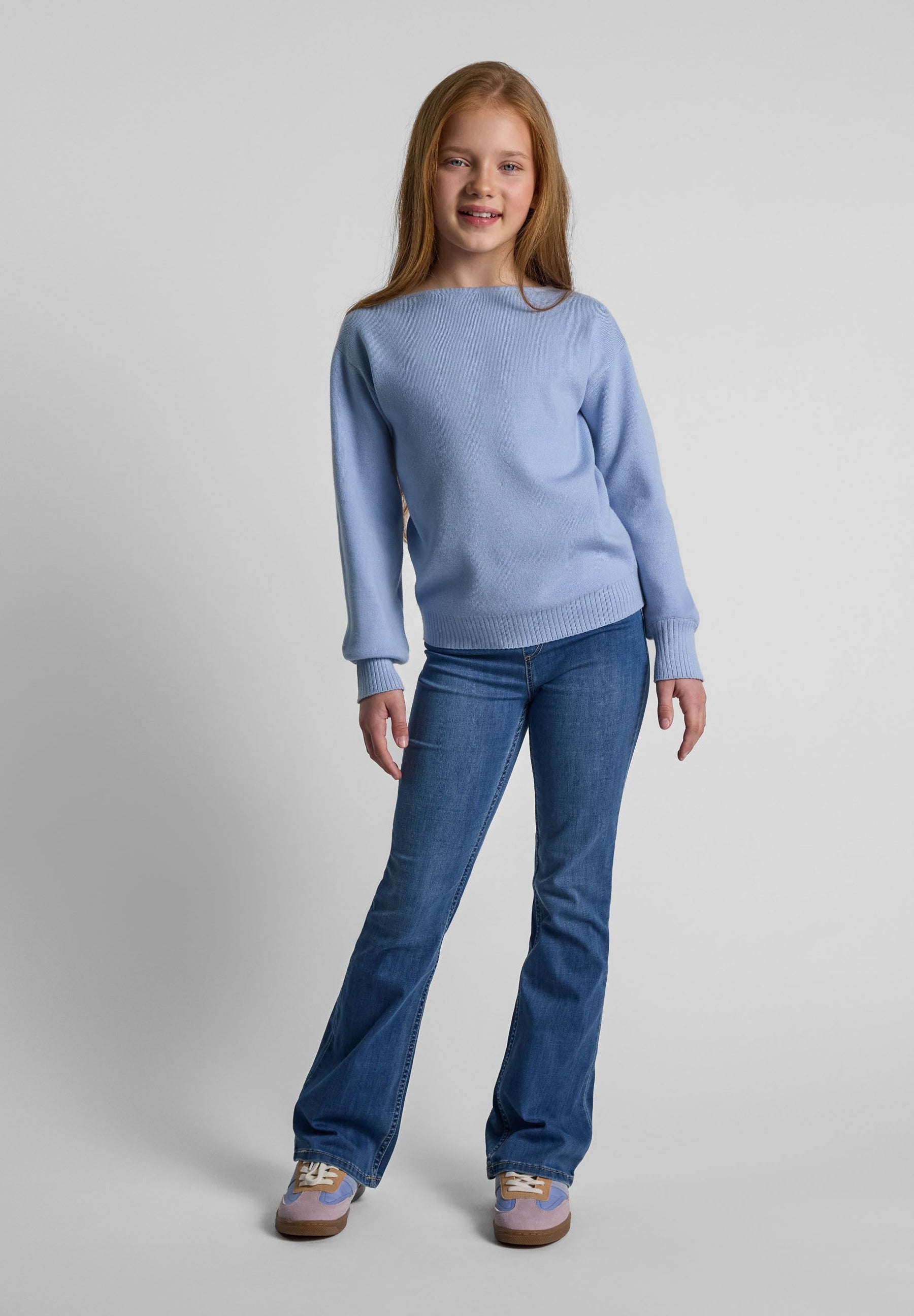 Girls light blue jumper with boat neckline and long sleeves, featuring ribbed cuffs.