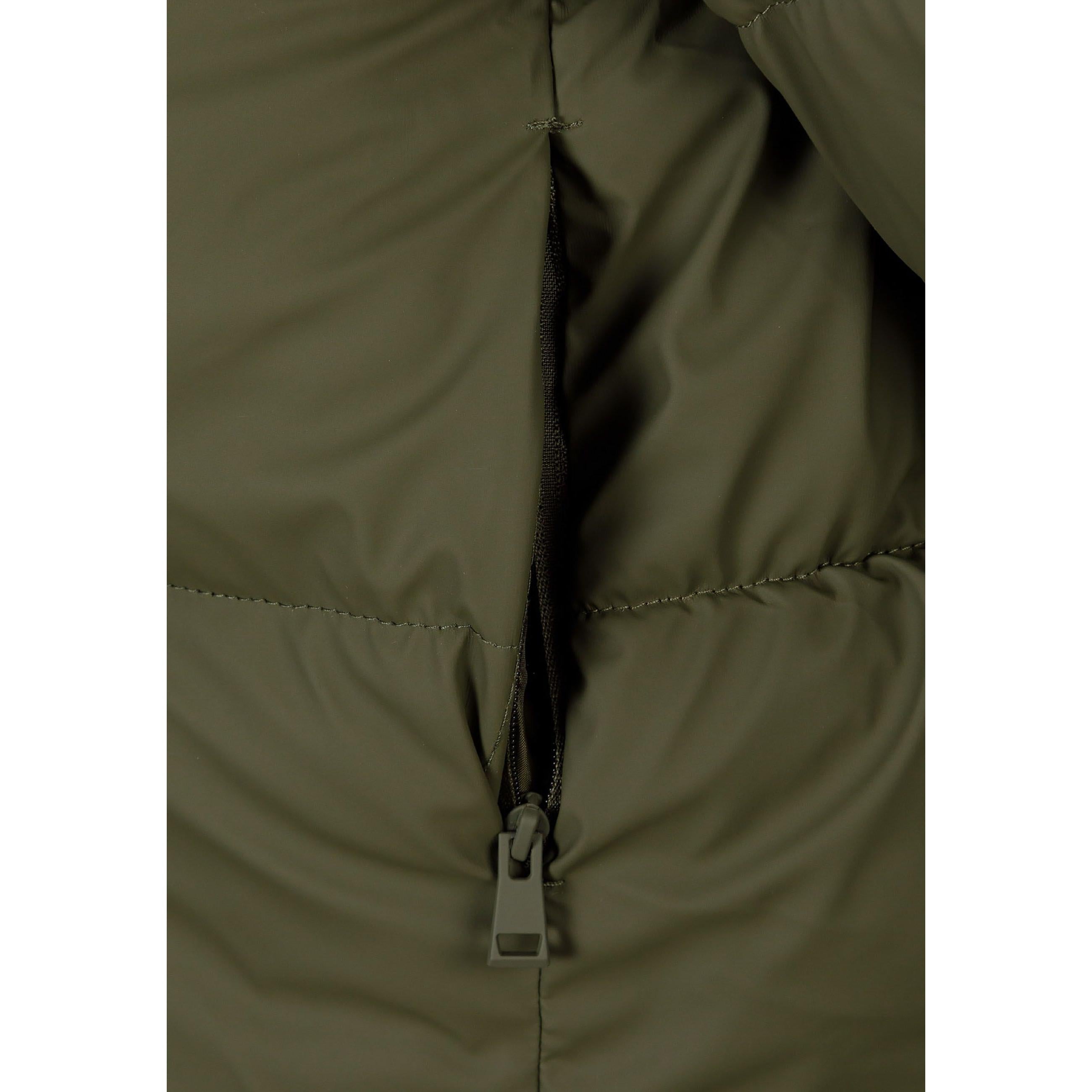 Close-up detail of khaki quilted jacket showing front zip fastening and quilted texture pattern