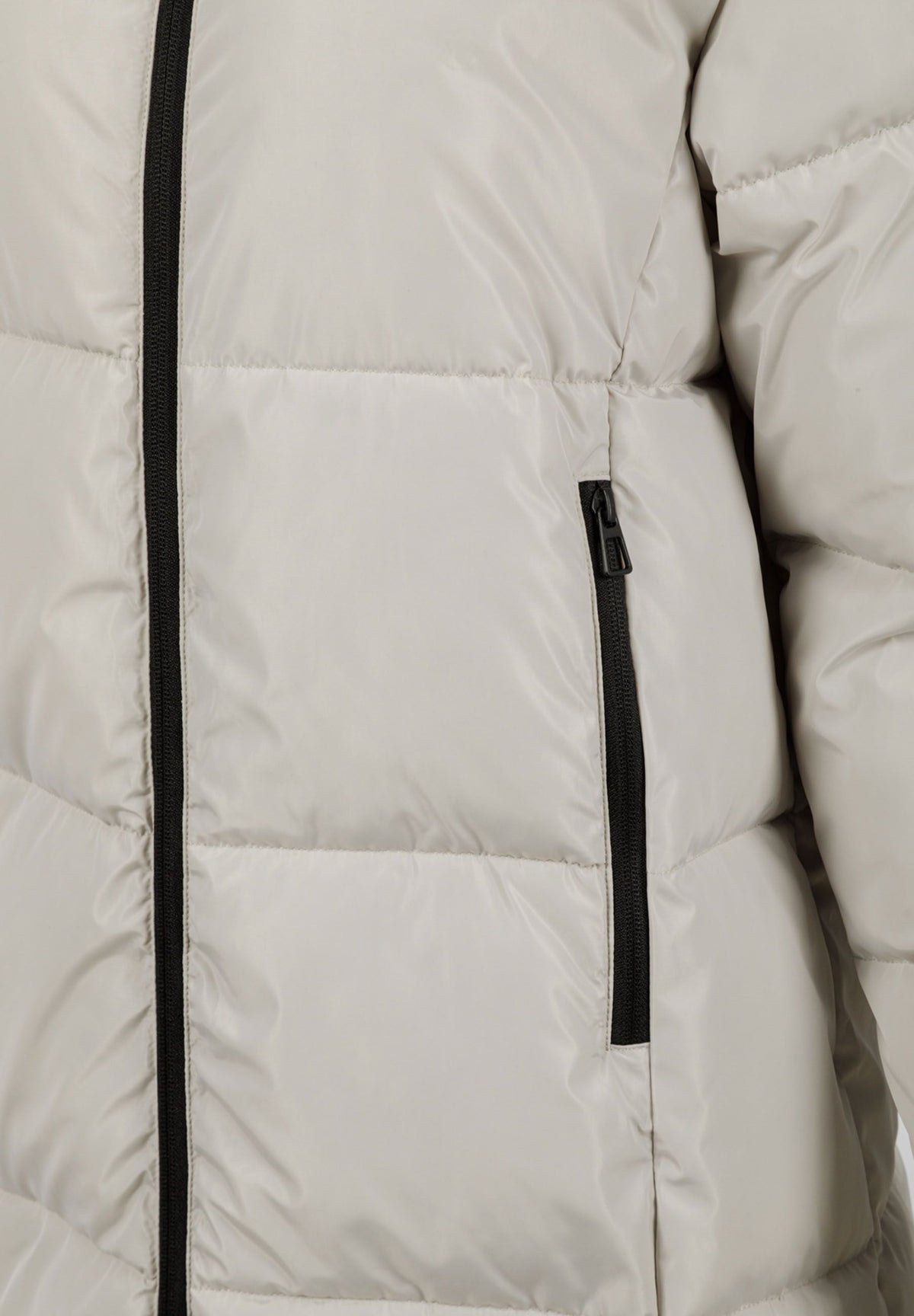 Close-up of the pocket on the beige long puffer coat.