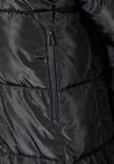 Detail of a black long quilted winter jacket featuring a zipped pocket.