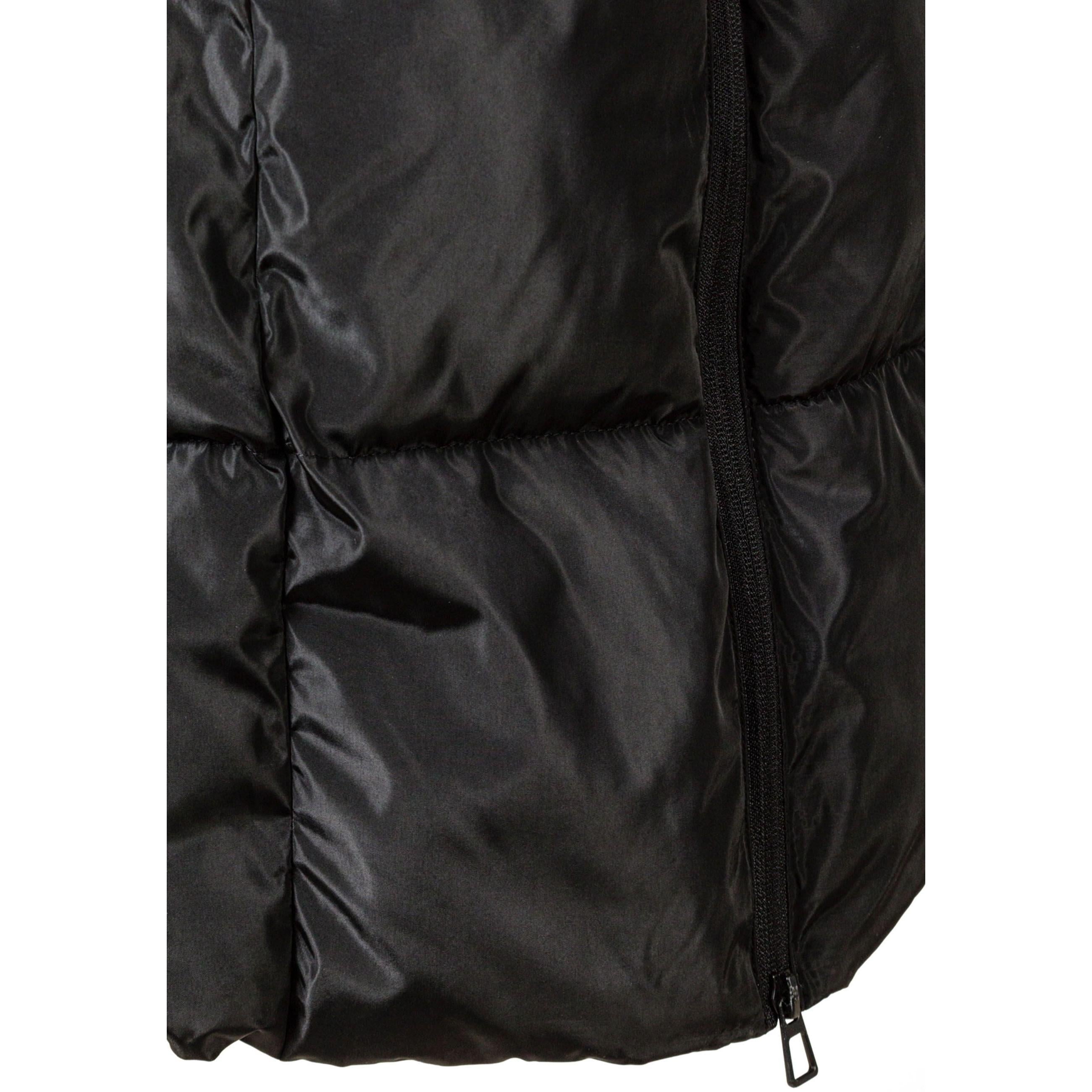 Close-up detail of black quilted jacket showing zip closure, quilted padding texture and drawstring hood cord