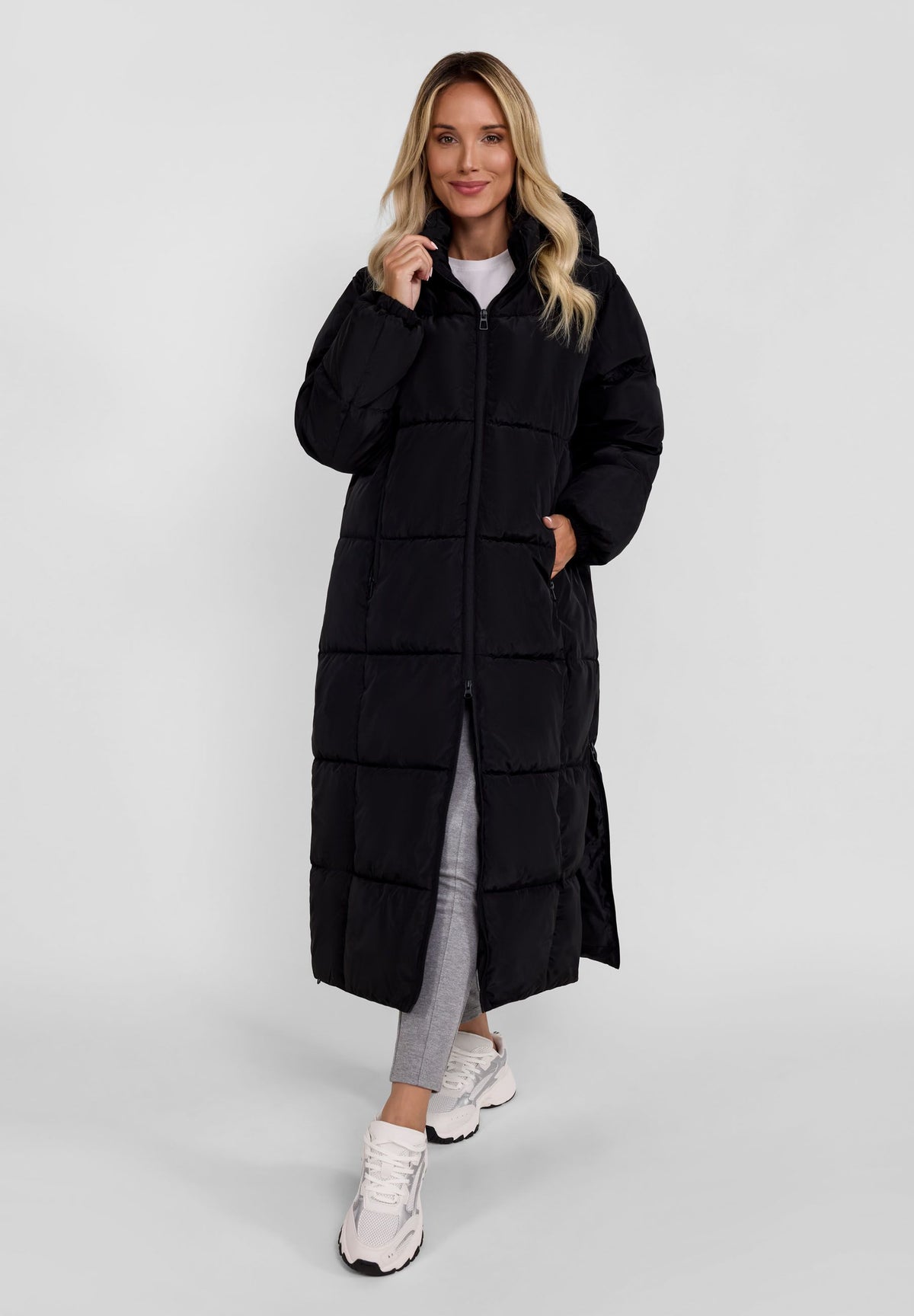 Women's black long puffer coat, shown worn.