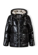 Black quilted short hooded jacket with zip and flap pockets, front view.