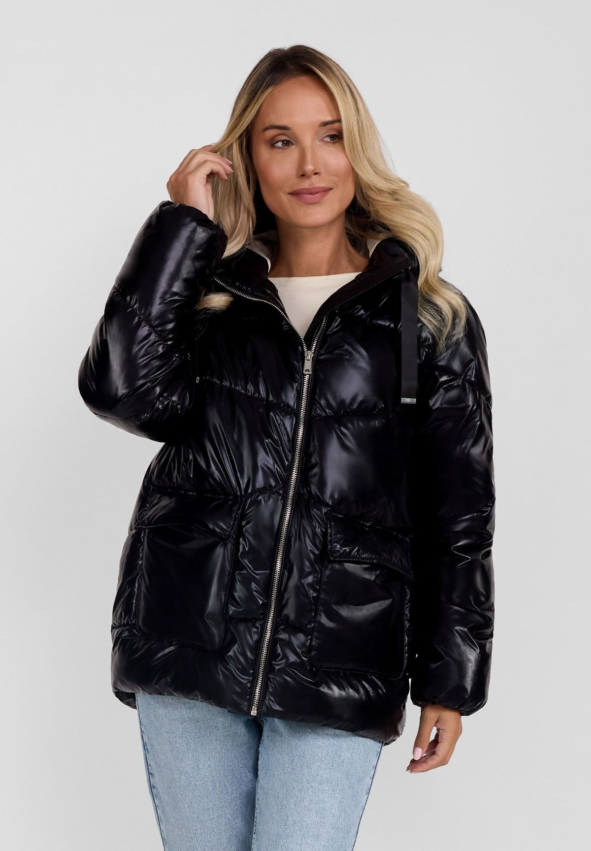 Women's black puffer jacket, shown worn.