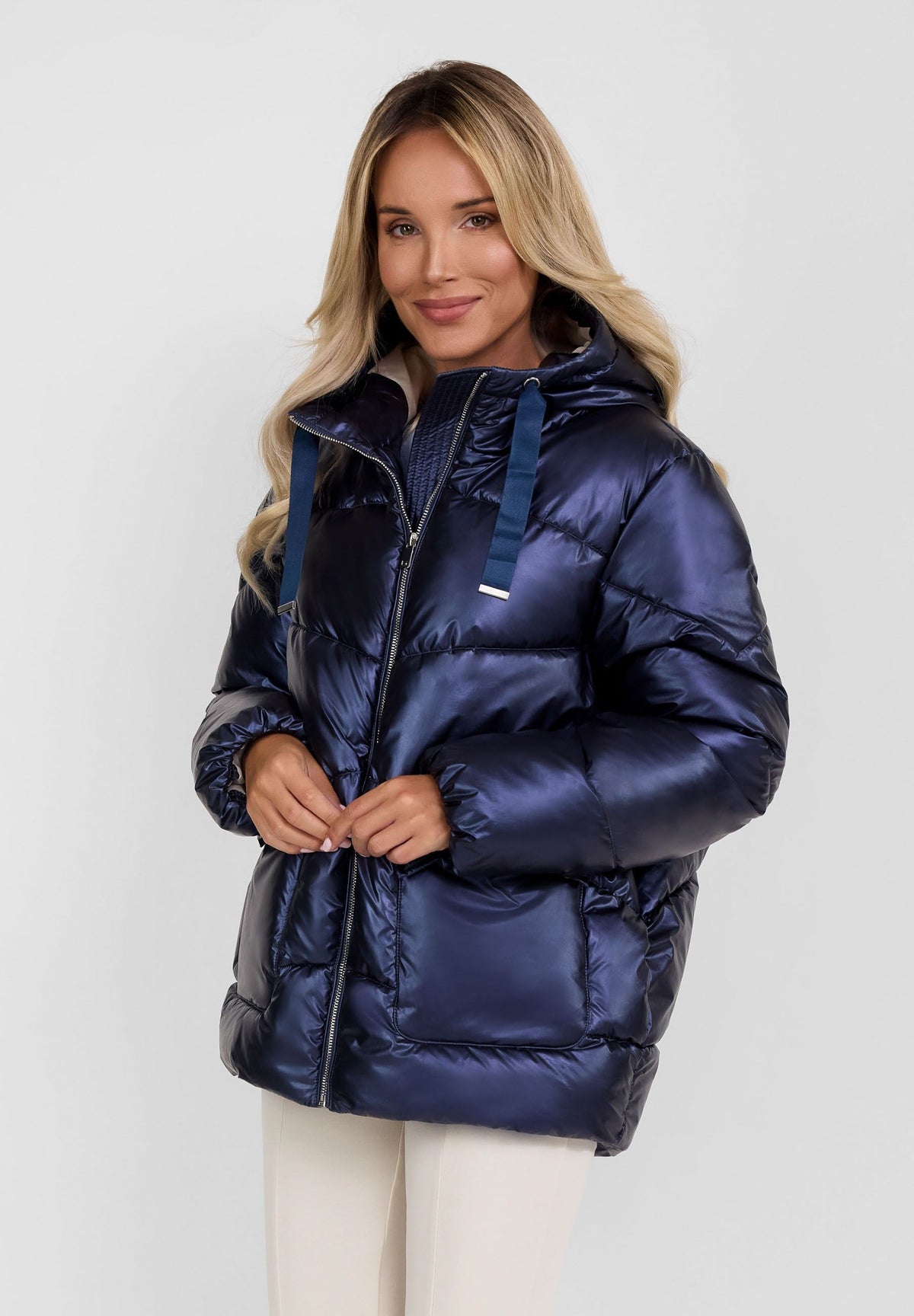 Women's navy puffer jacket, shown worn.