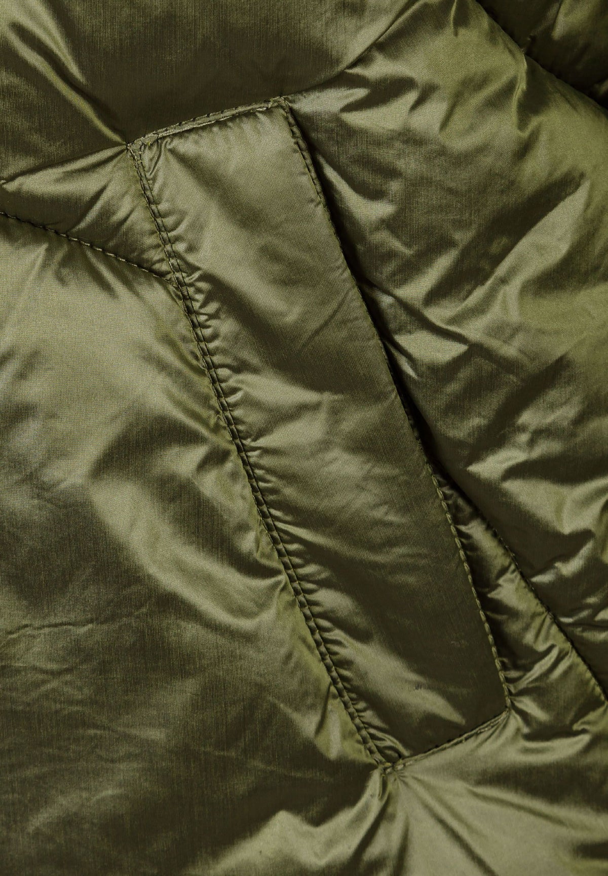 Close-up of the pocket on the khaki puffer jacket.