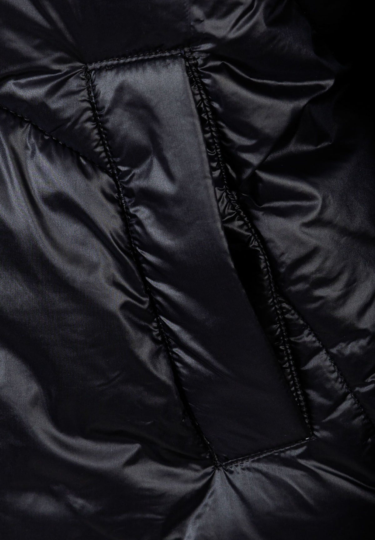 Close-up of the pocket on the black puffer jacket.
