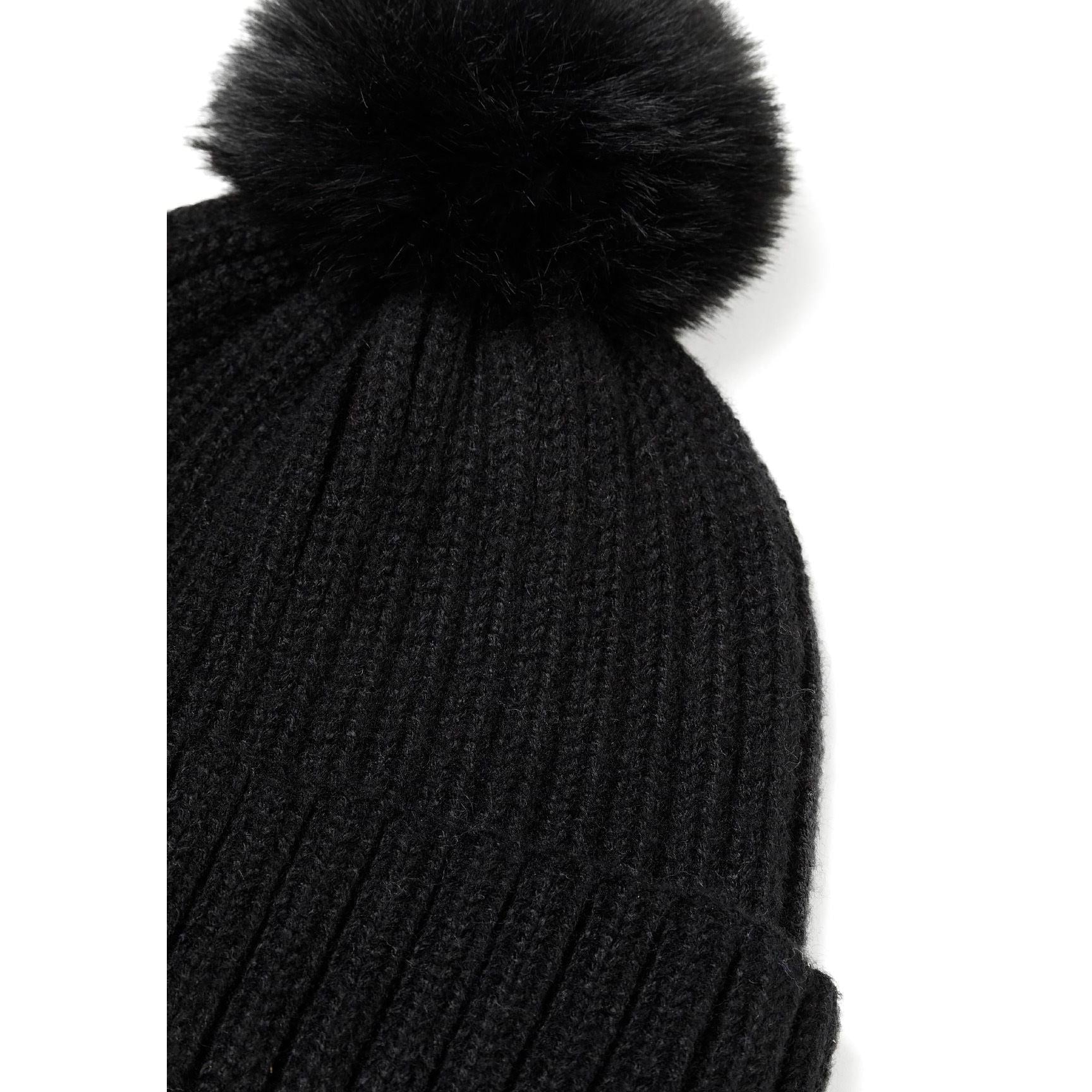Flat lay of black ribbed knit snood showing the tubular construction and ribbed texture pattern against white background