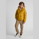 Boys mustard teddy-lined hooded jacket with zip and snap closure, flap pockets, and sleeve badge.