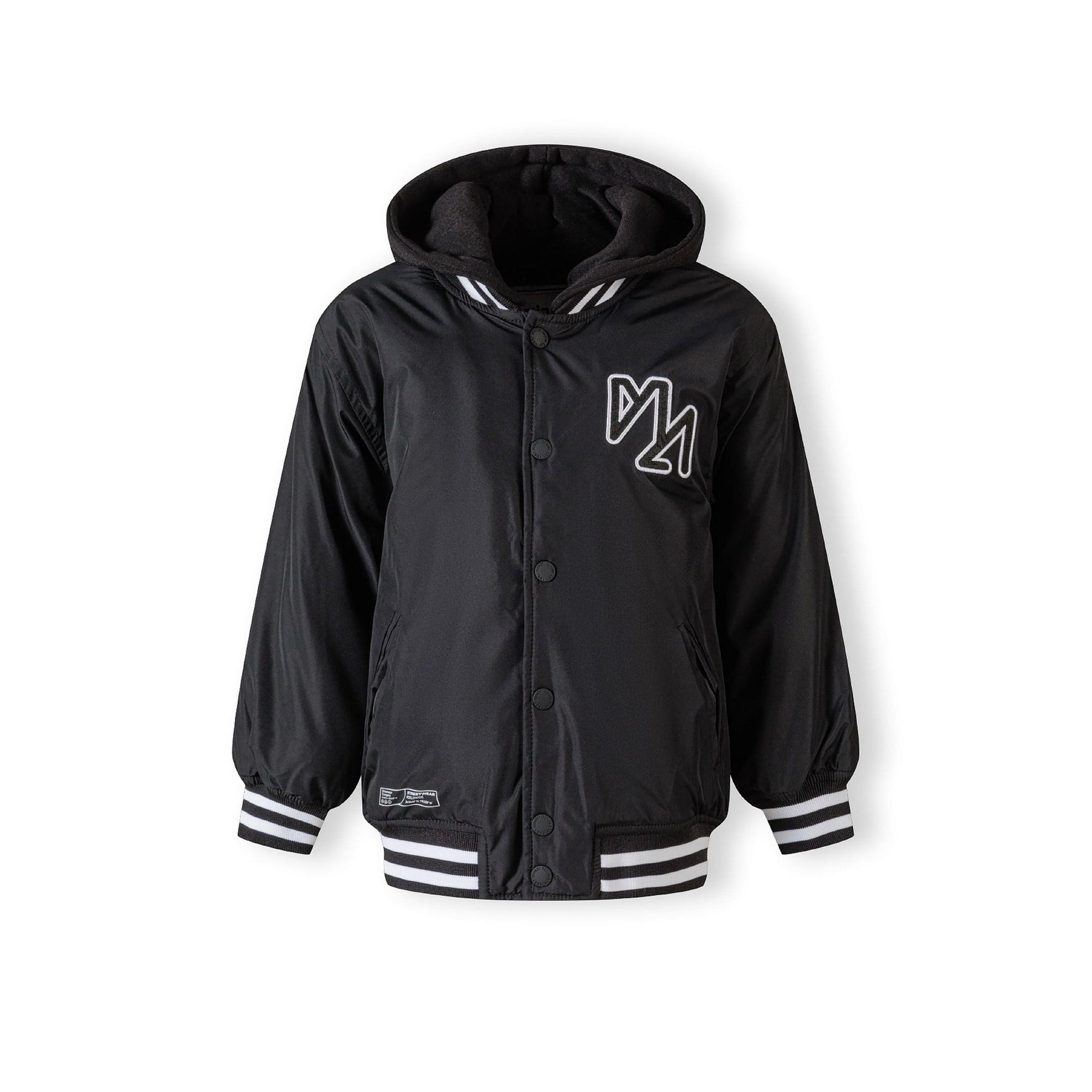 Close-up detail of black baseball jacket showing white embroidered logo and snap button closure with striped ribbed trim